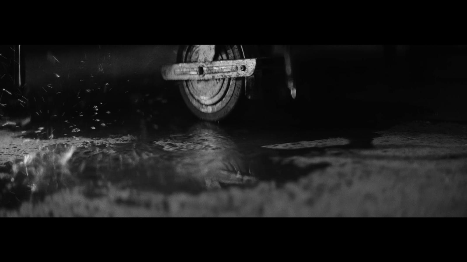 a black and white photo of a car's tire