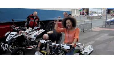 a woman riding on the back of a motorcycle next to a man