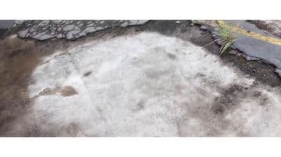 a patch of snow on the ground next to a road