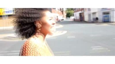 a woman standing on the side of a road