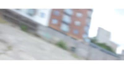 a blurry photo of a building and a wall