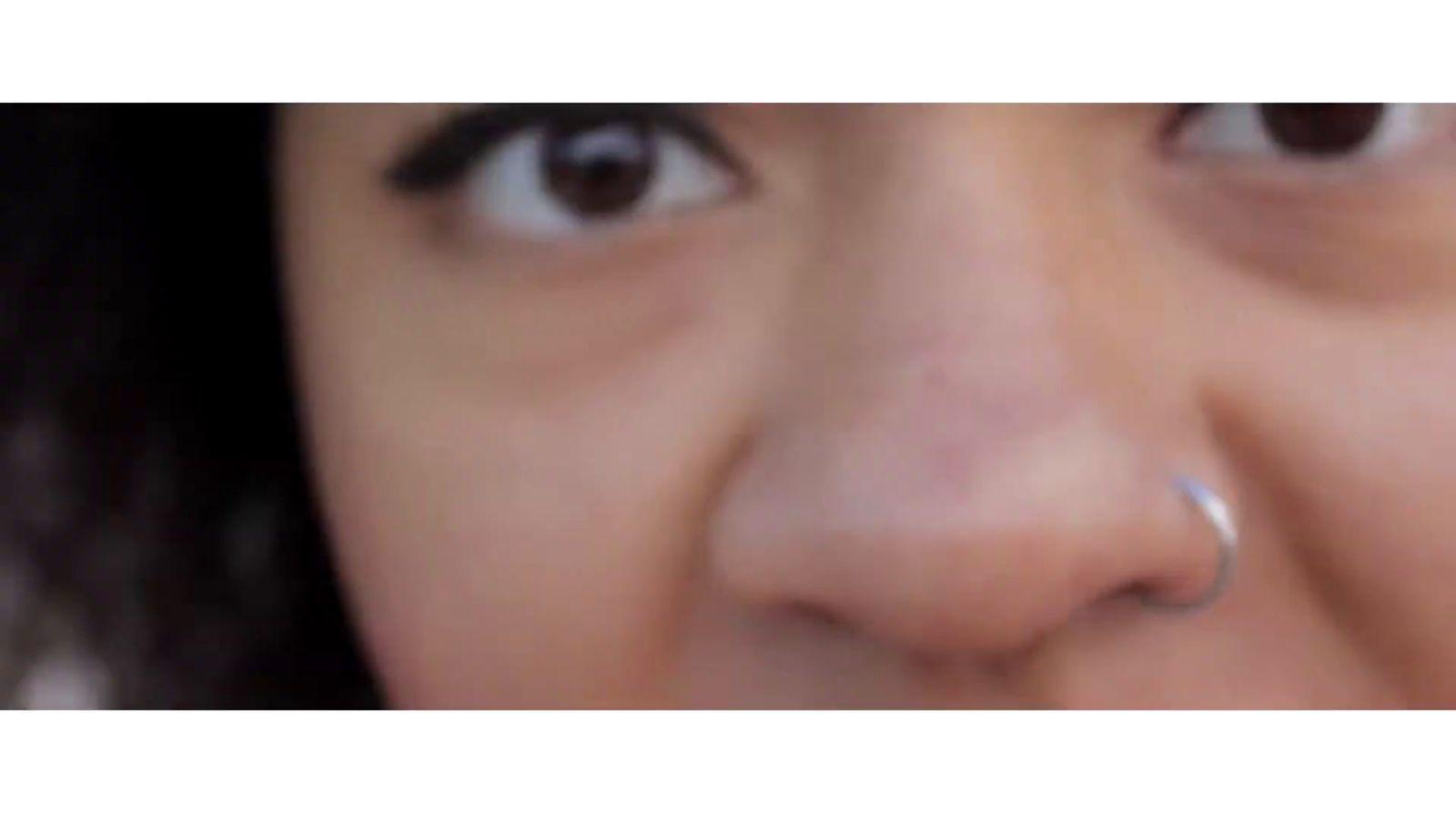 a close up of a person with a nose ring
