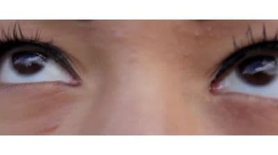 a close up of a person's eye with long lashes