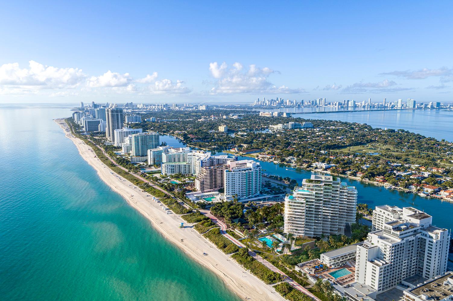 an aerial view of a city and the ocean