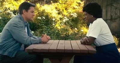 a man and a woman sitting at a picnic table
