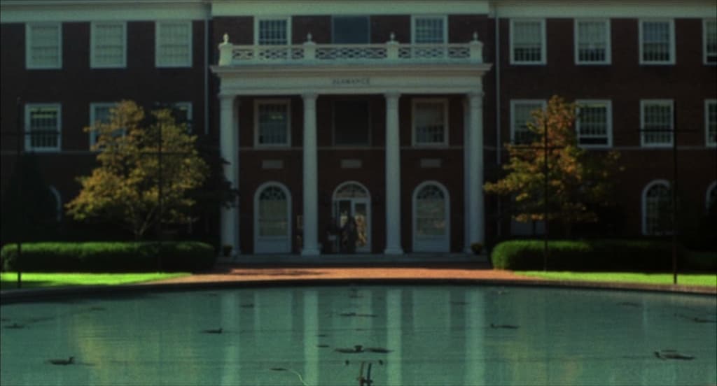 a large building with a fountain in front of it
