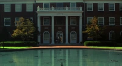 a large building with a fountain in front of it