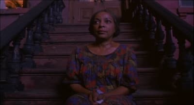 a woman sitting on a set of stairs