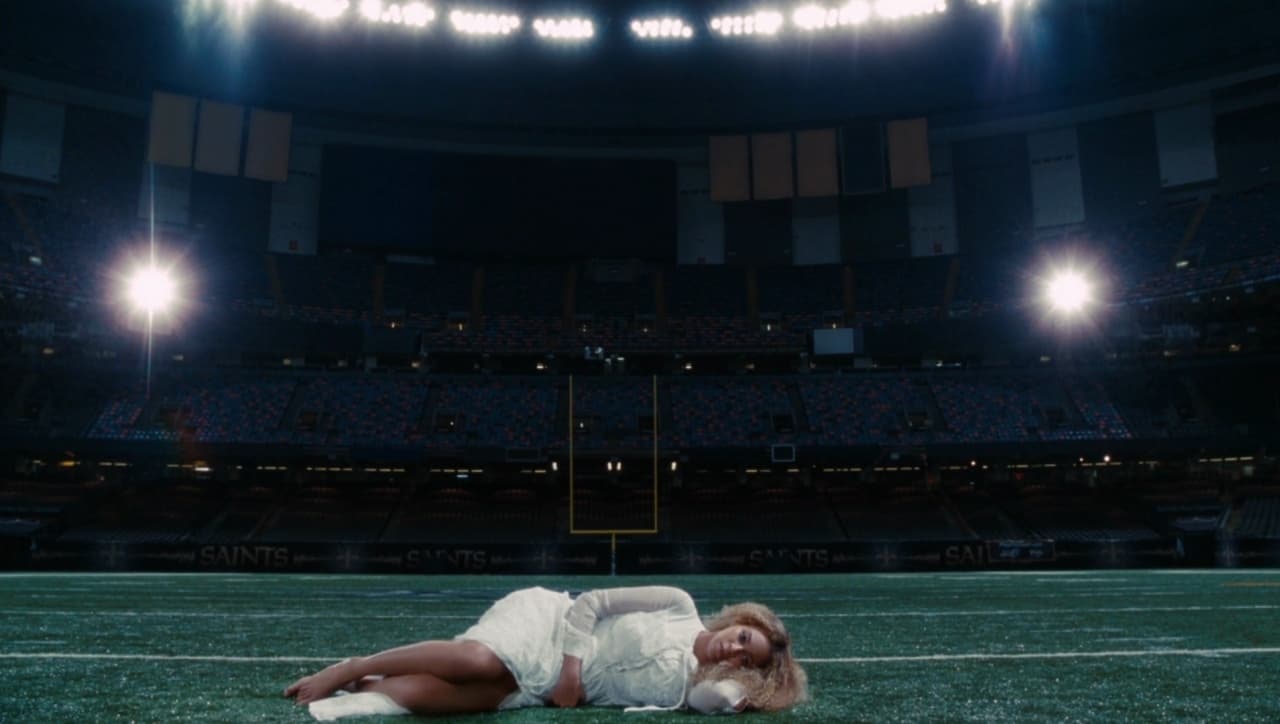 a woman laying on the ground in a stadium
