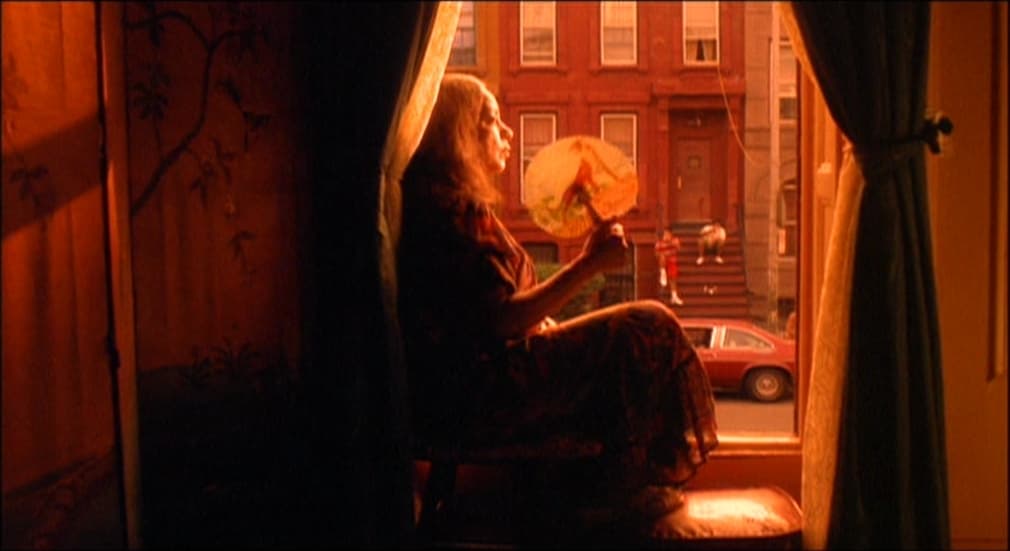 a woman sitting in a chair looking out a window