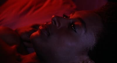 a close up of a person laying in a bed