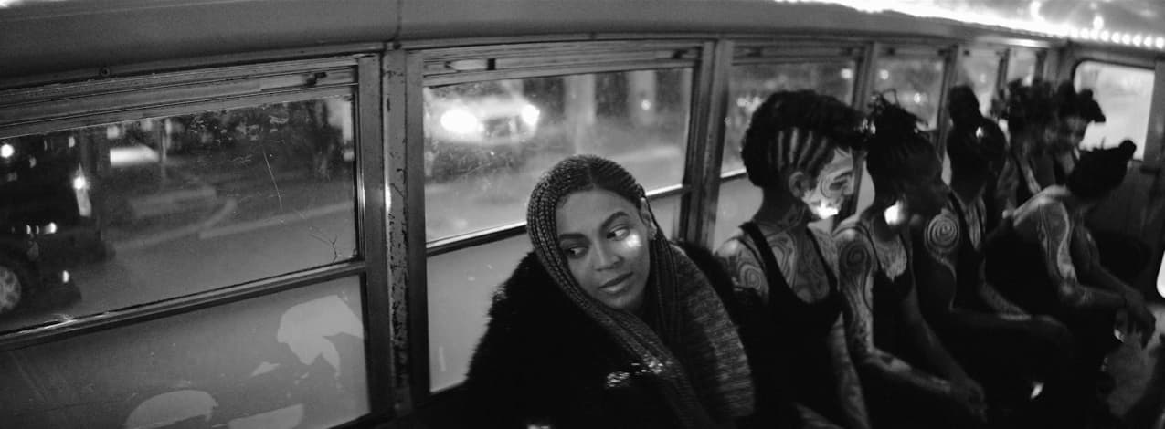 a black and white photo of a group of people on a bus