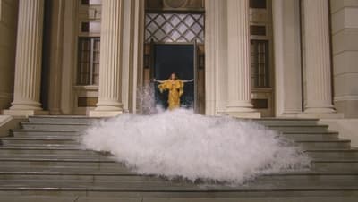 a person standing on a set of stairs in front of a building