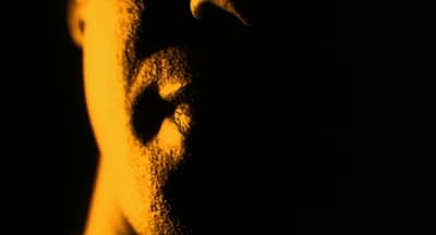 a close up of a person's face in the dark