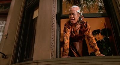 a woman standing in a window with a surprised look on her face