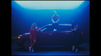 a group of people standing next to a car