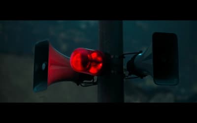 a red traffic light sitting on top of a metal pole