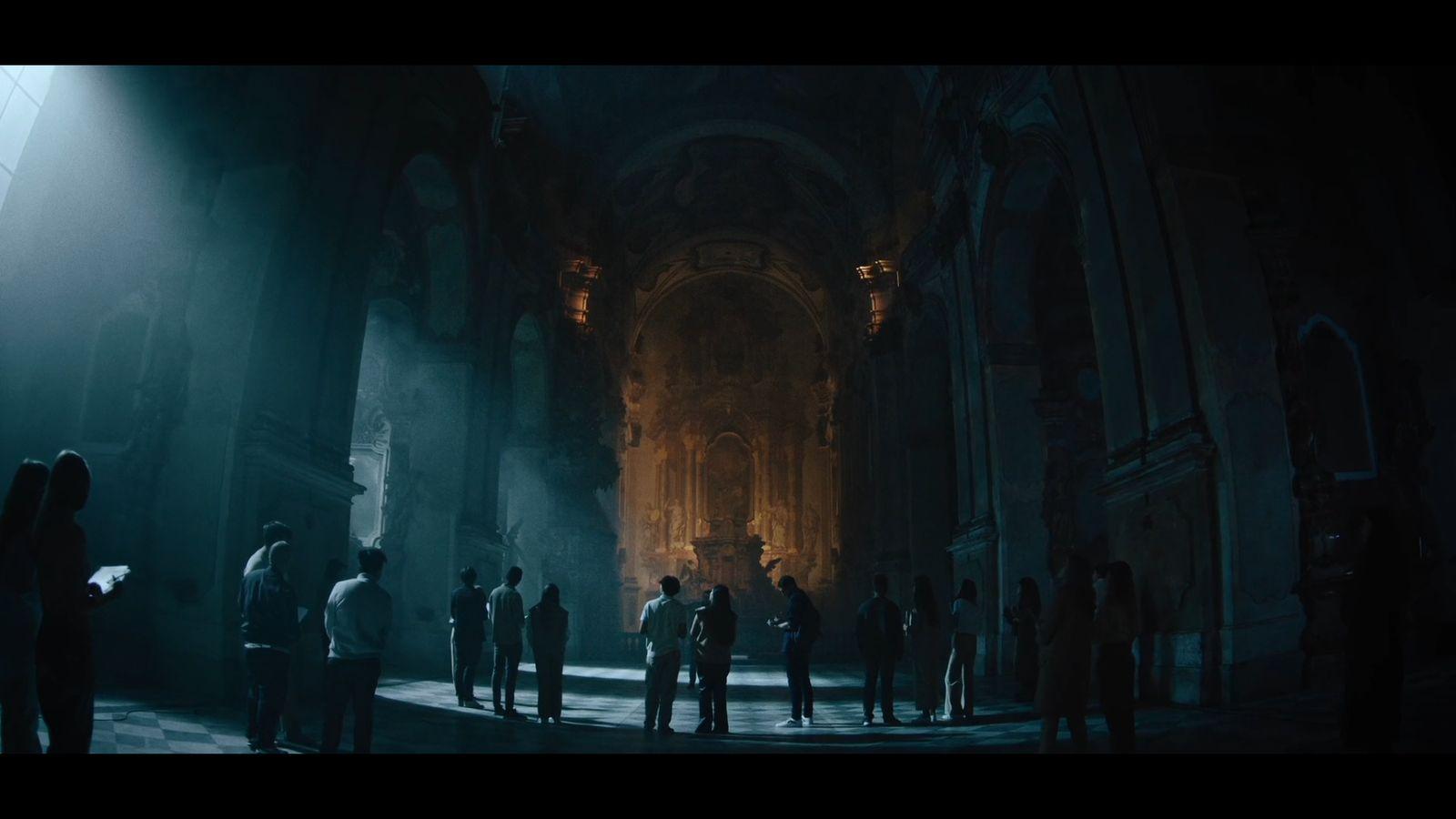 a group of people standing in a dark room