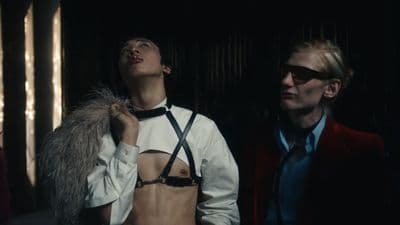 a man and a woman standing in a dark room