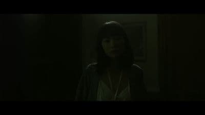 a woman standing in a dark room in the dark