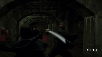 a group of people in a tunnel with a sword
