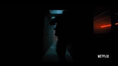 a person standing in a dark hallway at night