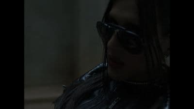 a woman wearing sunglasses and a leather jacket