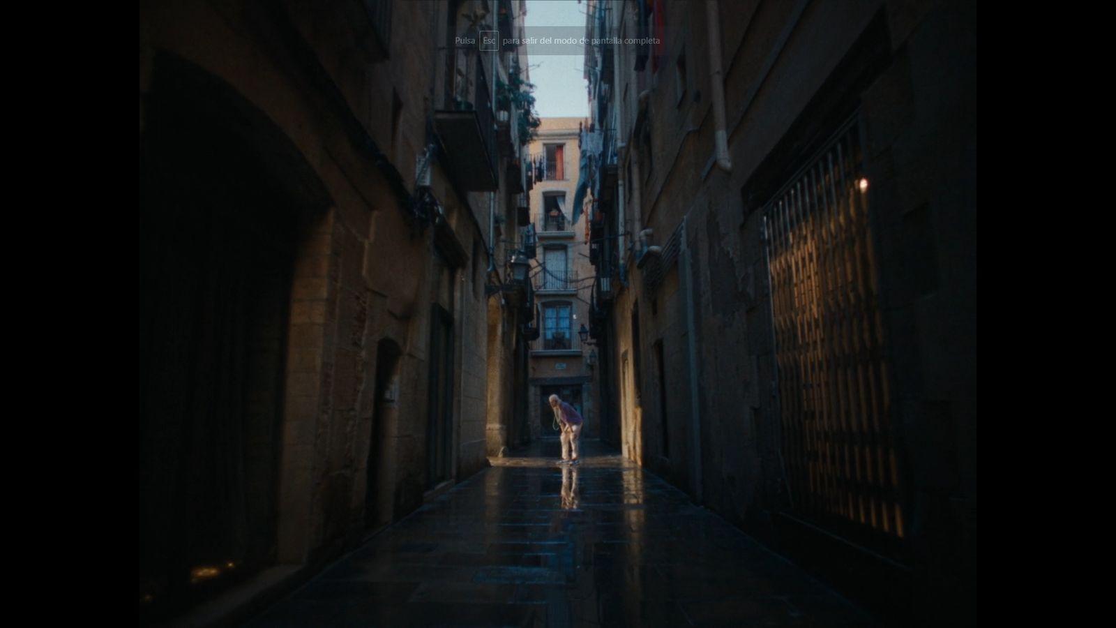 a person walking down a dark alley way