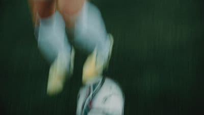 a blurry photo of a person kicking a soccer ball