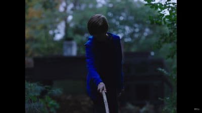 a person in a blue coat holding a white frisbee