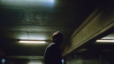 a person standing in a dark room with lights on
