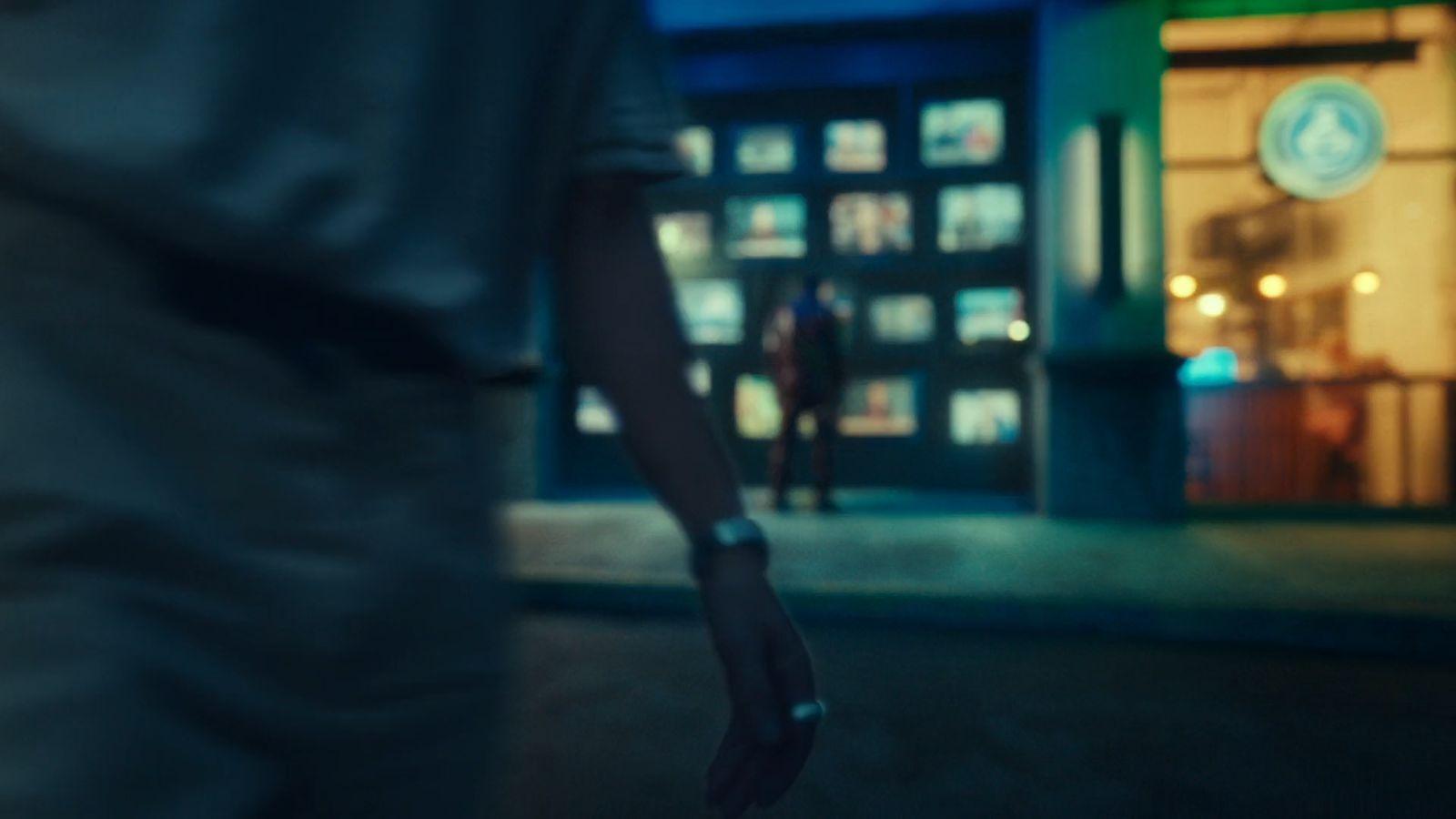 a person walking down a street at night