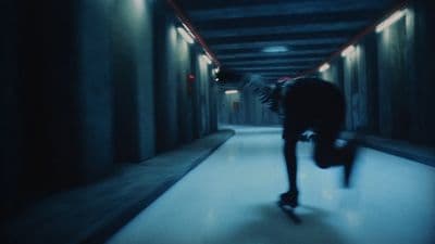 a man riding a skateboard down a hallway