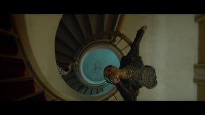 a man standing in front of a spiral staircase