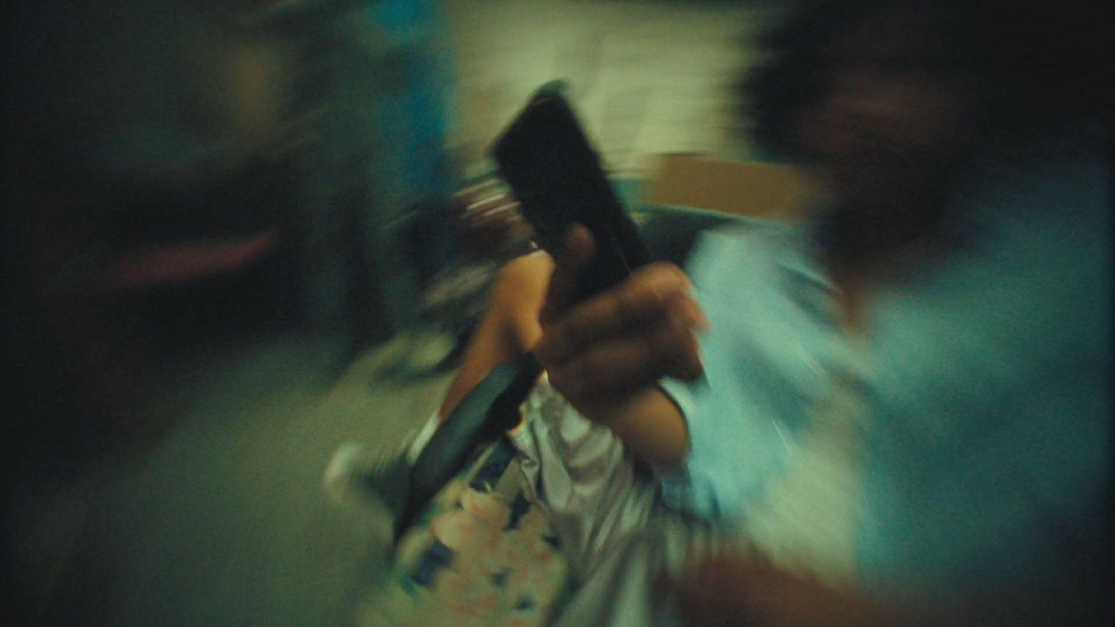 a blurry photo of a woman holding a cell phone