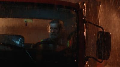 a man driving a truck in the rain
