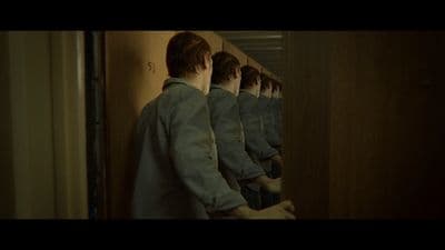 a man standing in front of a mirror in a room