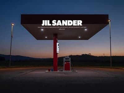 a gas station at night with the lights on