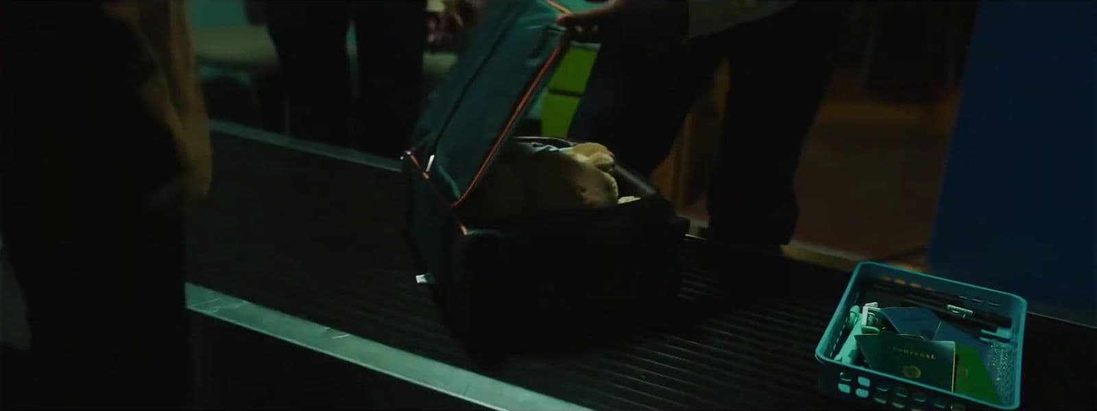 a group of people standing on a train next to a luggage bag