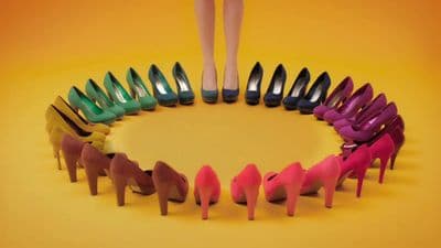 a circle of different colored high heeled shoes