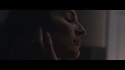 a woman with her hands on her ear