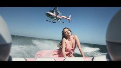 a woman in a pink dress is on a boat