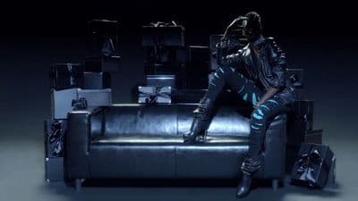 a man sitting on top of a leather couch