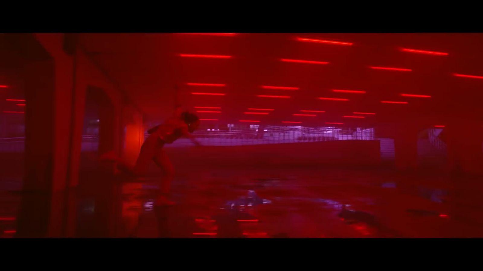 a man standing in a room with red lights