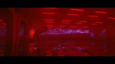 a man standing in a room with red lights