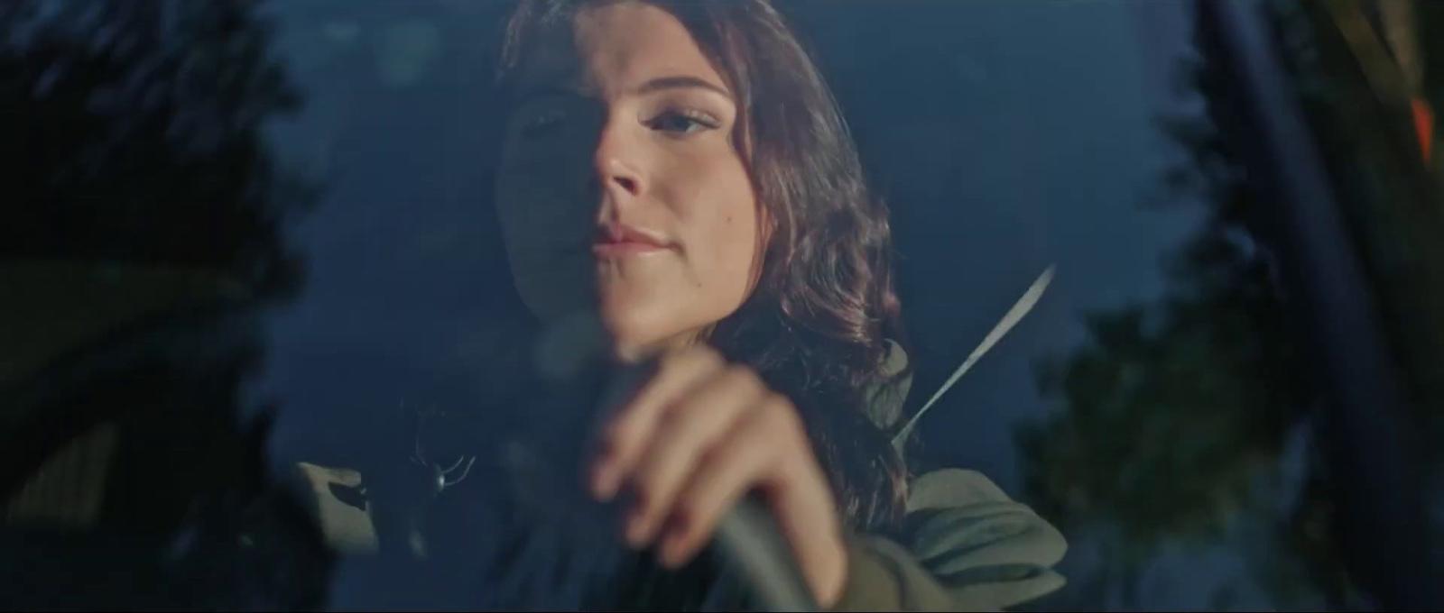 a woman sitting in the passenger seat of a car