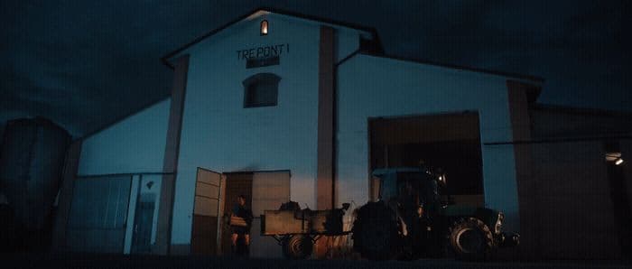 a tractor parked in front of a white building