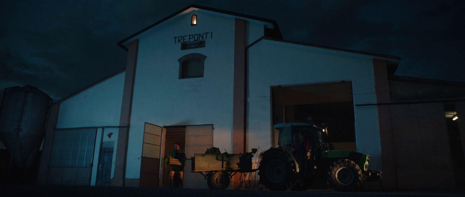 a tractor parked in front of a white building