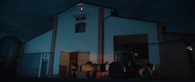 a tractor parked in front of a white building