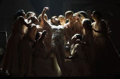 a group of women standing on top of a stage